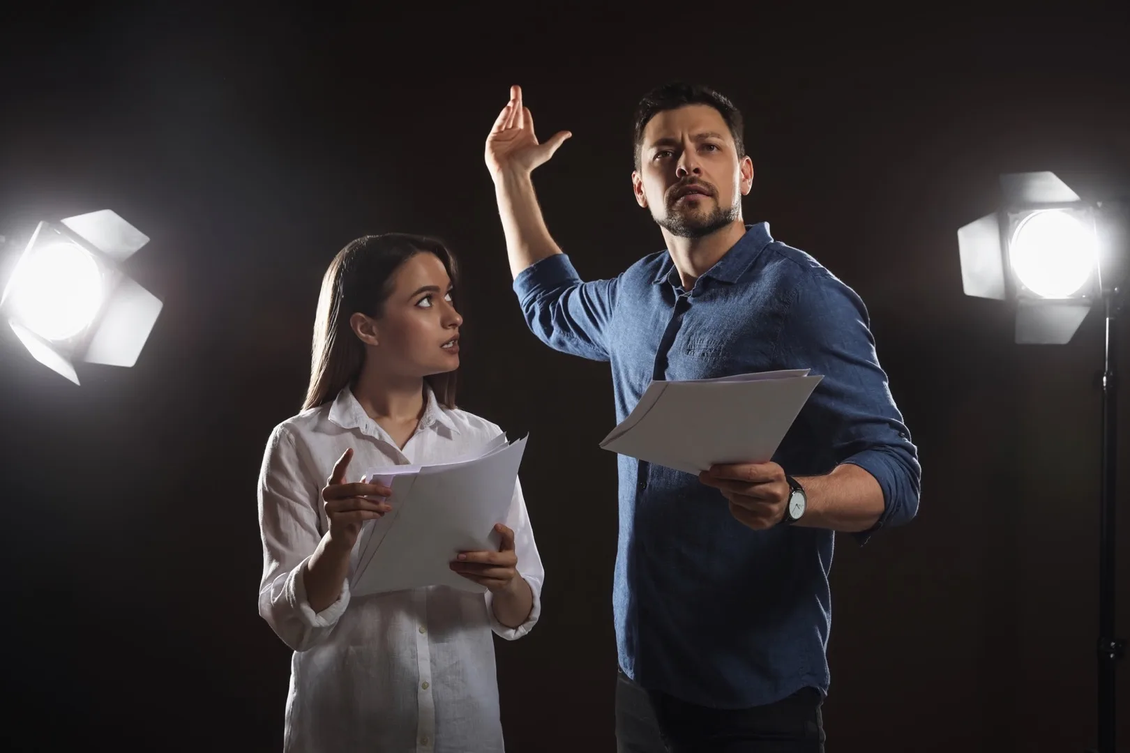 Actors rehearsing a scene on a theatre stage