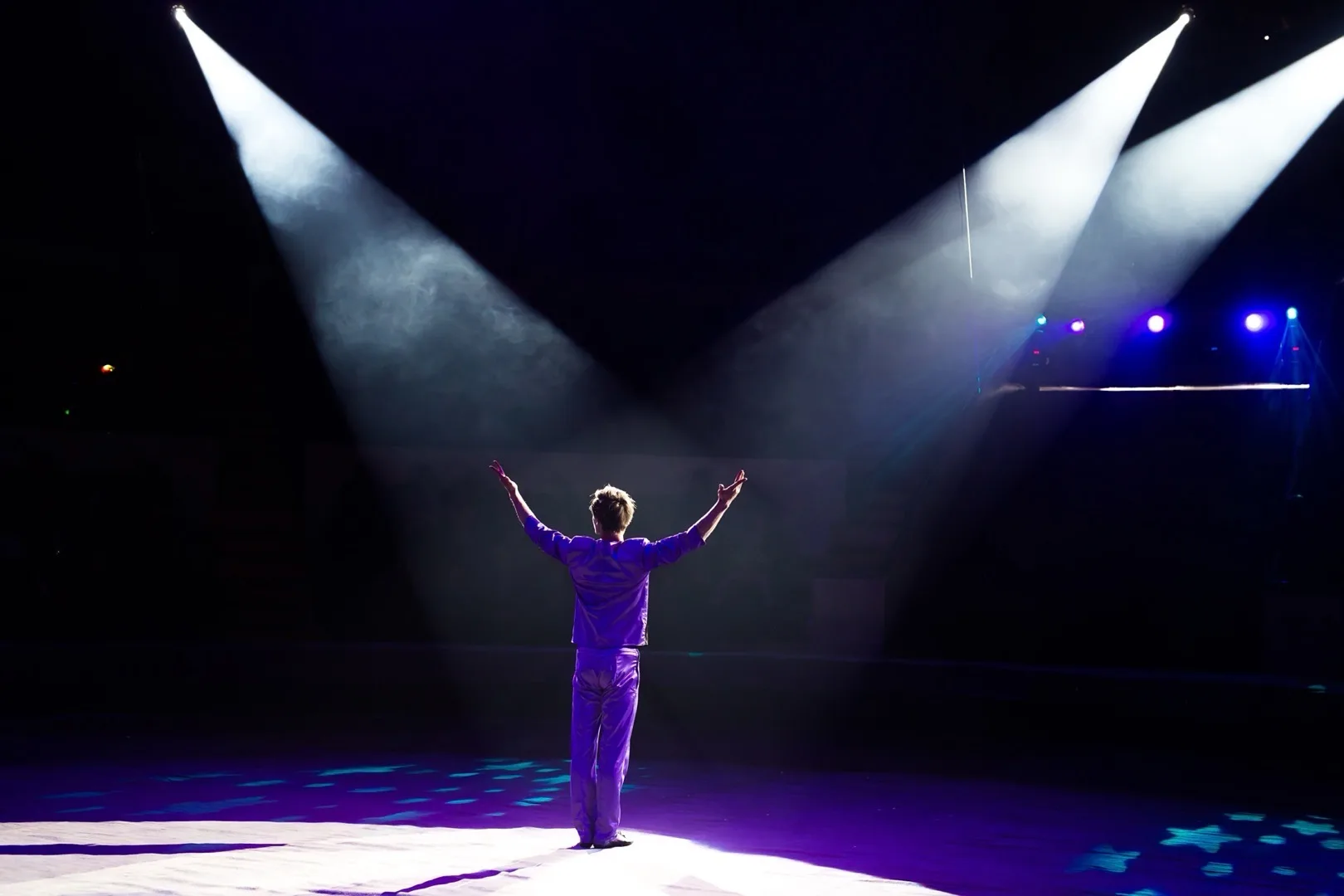 Actor performing under stage lights